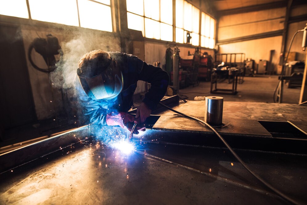 professional-welder-protective-uniform-helmet-welding-metal-part-workshop_342744-518.jpg